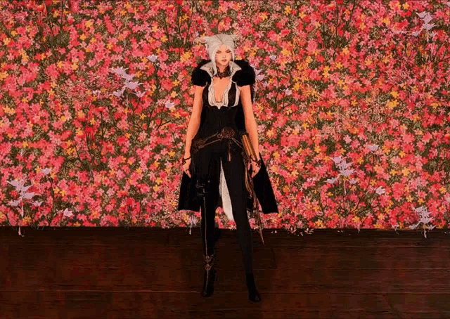 a woman is standing in front of a wall of pink flowers