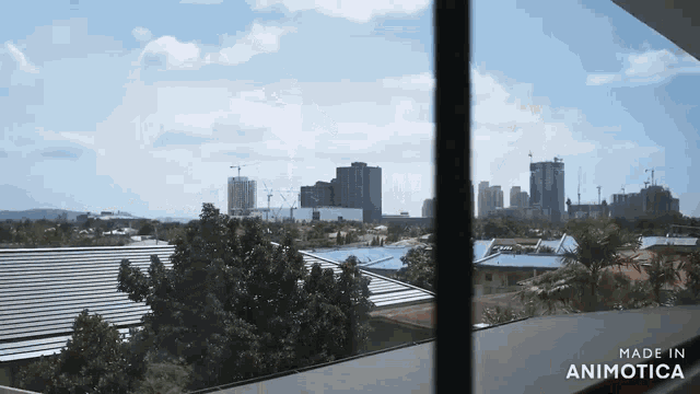 a window with a view of a city and the words made in animotica
