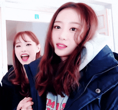 two girls are standing next to each other and one is wearing a shirt that says m