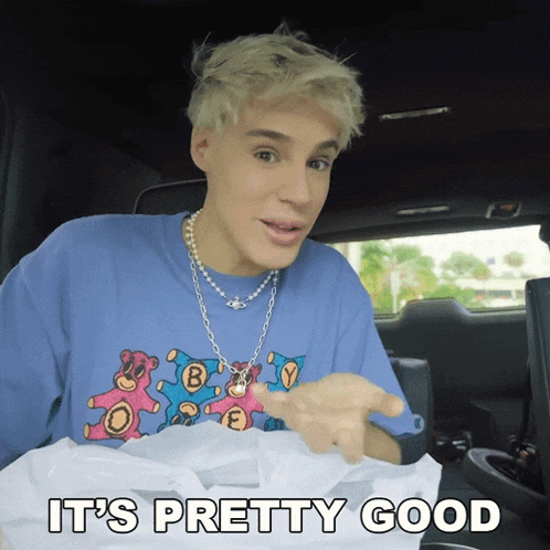 a man in a blue shirt says it 's pretty good in a car