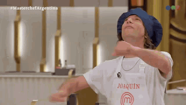 a man wearing a white shirt that says " joaquin " on it