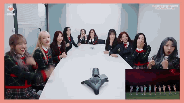a group of girls are sitting around a table with a sign that says ' seoul ' on it