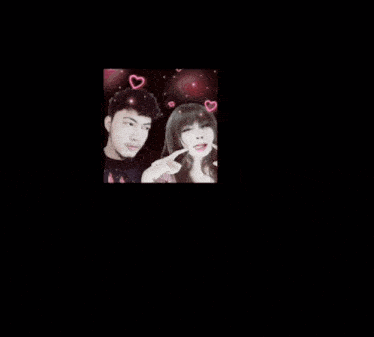 a man and a woman are posing for a picture with pink hearts on their head