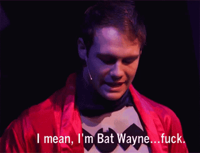 a man in a batman costume is saying " i mean i 'm bat wayne fuck "