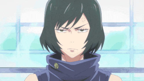 a girl with black hair and a scarf around her neck looks at the camera