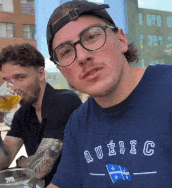 a man wearing a blue shirt that says quebec on it
