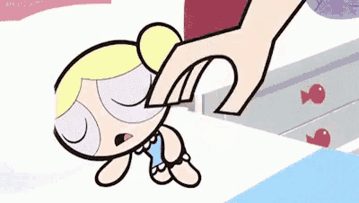 bubbles from the powerpuff girls is being held by someone 's hand .