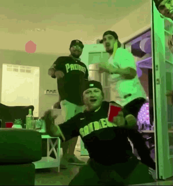 a man wearing a padres shirt is dancing with other men