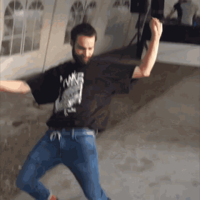 a man with a beard wearing a black shirt that says pawn on it