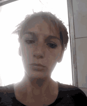 a close up of a woman 's face with a very serious look on her face