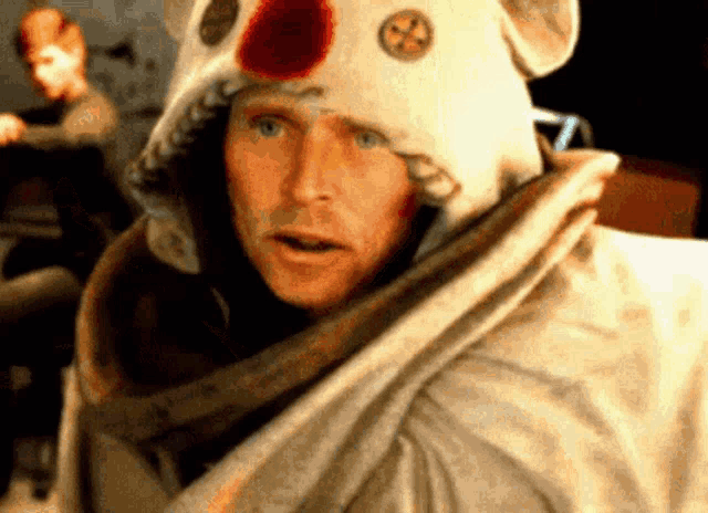 a man wearing a white hat with a red nose