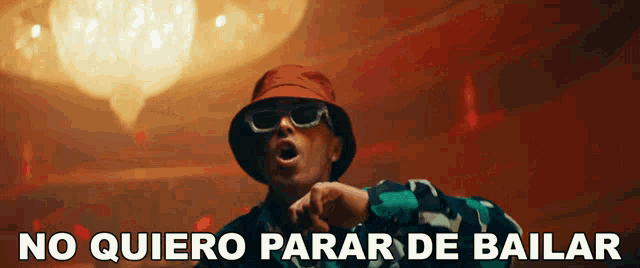 a man wearing a red hat and sunglasses says no quiero parar de bailar
