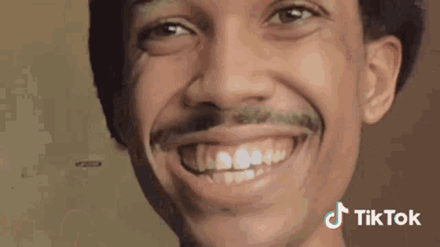 a close up of a man 's face with a tiktok logo