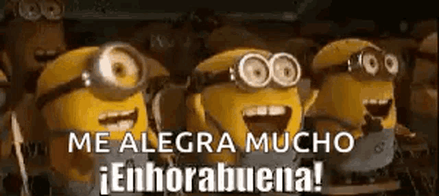 a group of minions are standing next to each other and laughing .