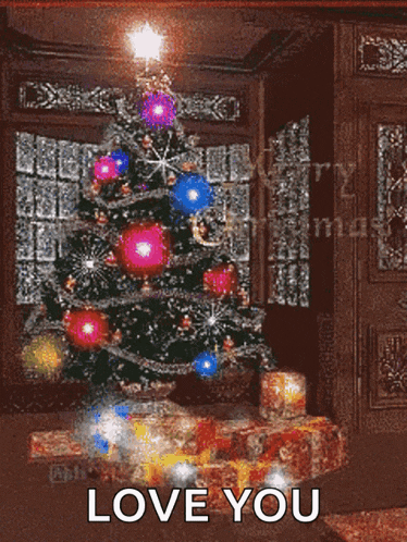 a christmas tree in a living room with the words " love you " on the bottom