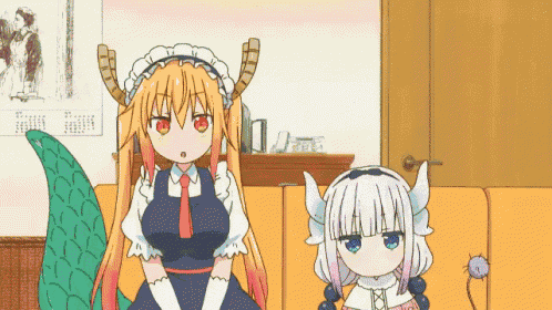 a couple of anime girls standing next to each other in a living room