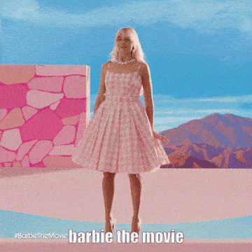 a barbie doll is dancing on a bed in a pink house