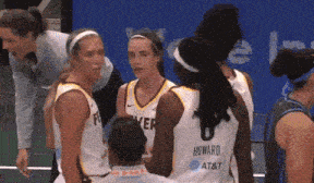 a group of female basketball players one of whom is wearing a number 8 jersey