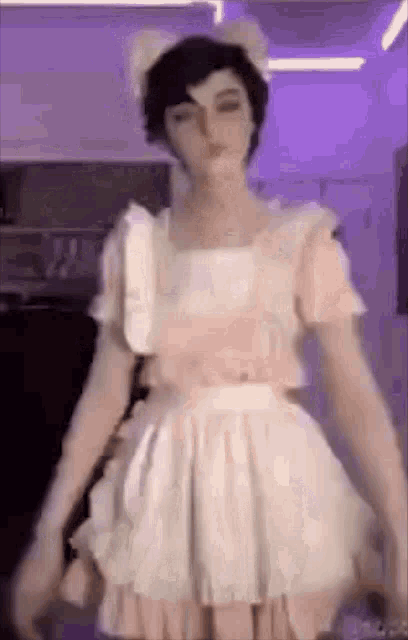 a person wearing a maid costume is standing in a room .