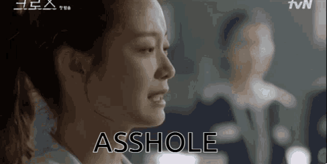 a close up of a woman 's face with the word asshole written on the bottom