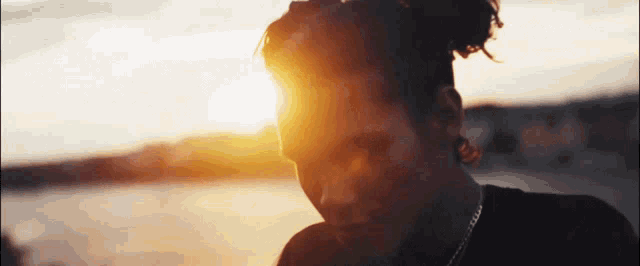 a close up of a person 's face with the sun shining on it