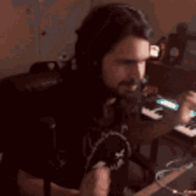 a man wearing headphones is playing a keyboard