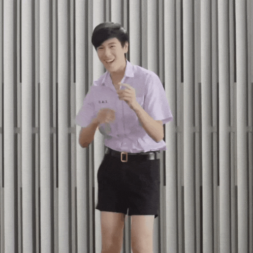a young man wearing shorts and a purple shirt has the number 863 on his shirt