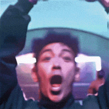 a close up of a man 's face with his mouth open .
