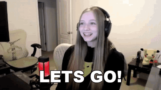a girl wearing headphones says lets go