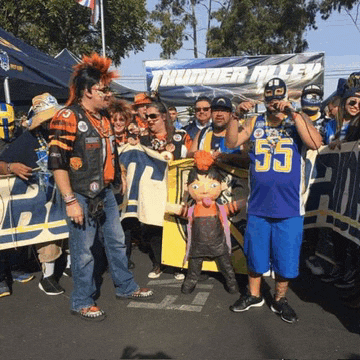 a group of people are standing in front of a sign that says thunder alley