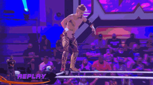 a replay of a wrestling match is shown with a purple background
