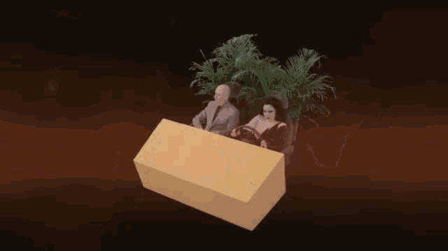 a man and a woman are sitting in a cardboard box car