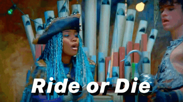 a woman in a pirate hat is standing next to a man with the words ride or die written above her