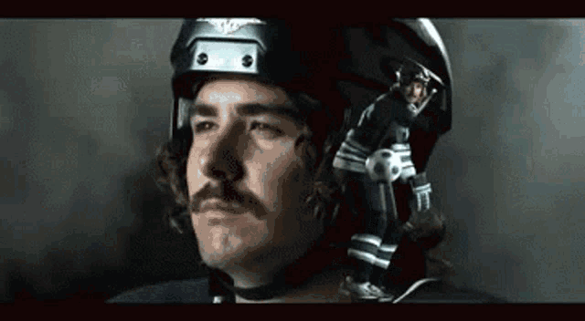 a man with a mustache wearing a hockey helmet with the letter e on it