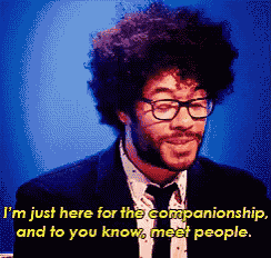 a man wearing glasses and a suit says " i 'm just here for the companionship "