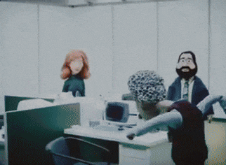 a man is standing on a desk in a room with a bunch of mannequins