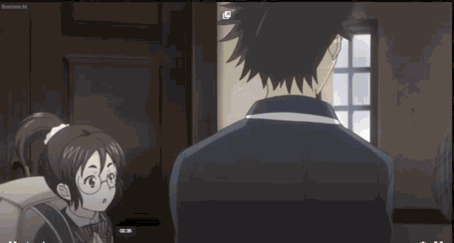 a man and a woman are standing next to each other in a room with a window in the background .