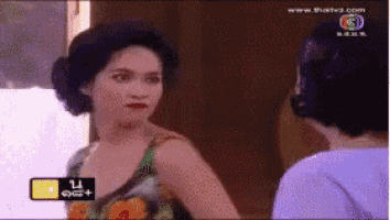 a woman in a floral dress is talking to another woman in front of a screen that says www.thaitv3.com
