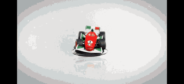 a red and green racing car with the number 1 on the front