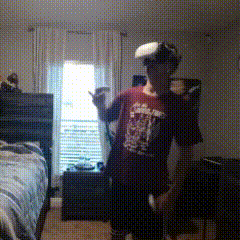 a young man wearing a virtual reality headset in a bedroom