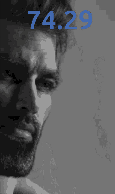 a black and white photo of a man with the number 74.29 on the bottom