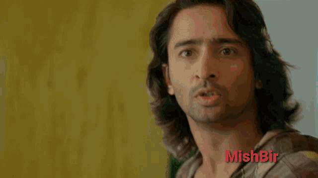 a close up of a man 's face with the word mishbir on the bottom right