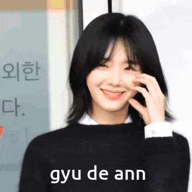 a woman is smiling with the words gyu de ann on the bottom right