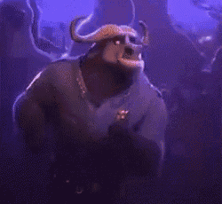 a man in a police uniform with horns is dancing in a crowd of people .