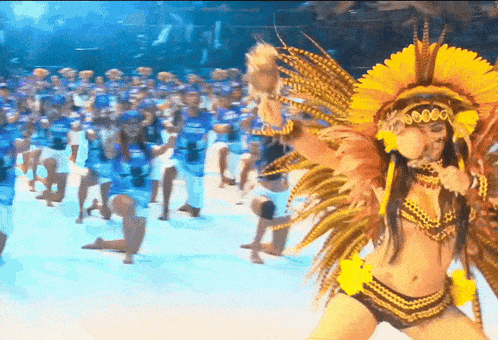 a woman in a native american costume is dancing in front of a crowd of people