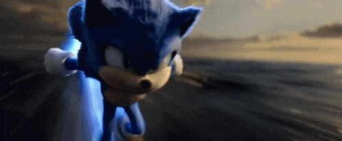 a close up of a blue sonic the hedgehog running on a road .