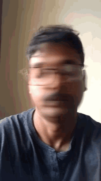 a blurry photo of a man 's face with glasses on