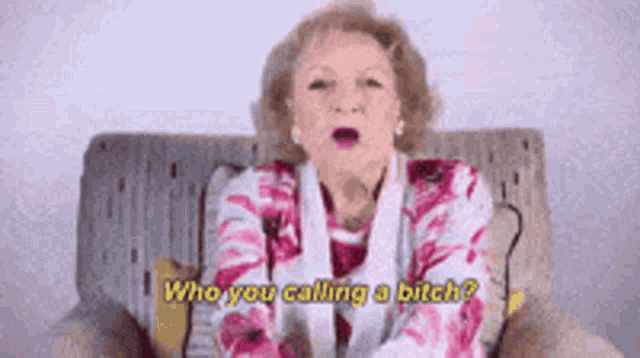 an elderly woman is sitting on a couch and saying who you calling a bitch ?