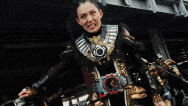 a woman in a costume with a red lightning bolt around her neck