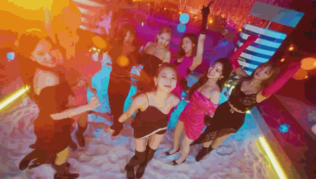 a group of women are dancing in a club .